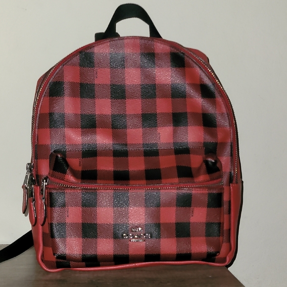 coach checkerboard backpack Medium Charlie Leather in Buffalo Plaid Strawberry Signature coated canvas and smooth leather Inside zip cell phone and multifunction pockets Laptop compartment with zip closure Zip closure recycled polyester lining Top handle with 3 drop Outside zip pocket Luggage sleeve Adjustable shoulder straps Fits a 16 laptop 11 3/4 (L) x 16 1/2 (H) x 6 (W) Style No. Coach jordyn backpack in -